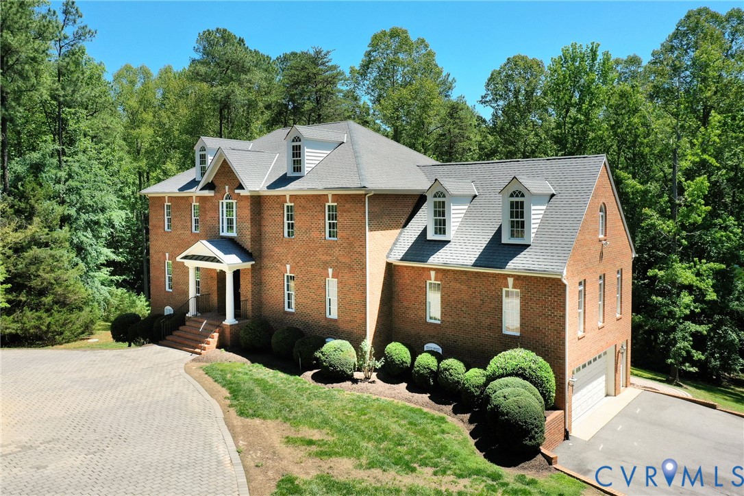 1295 Hermitage Road Manakin-Sabot, VA 23103 - Photo 1 of 55 a front view of a house with a yard and trees