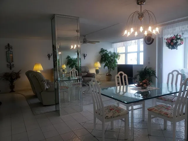 a dining room with furniture and chandelier
