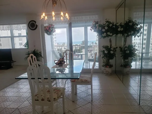 a view of a dining room with furniture and a chandelier
