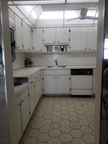 a kitchen with stainless steel appliances a sink and a refrigerator