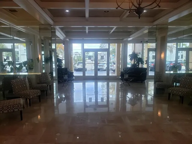 a lobby with furniture and floor to ceiling window