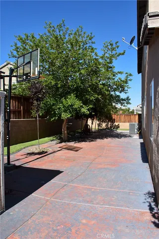 a view of a backyard with wooden fence