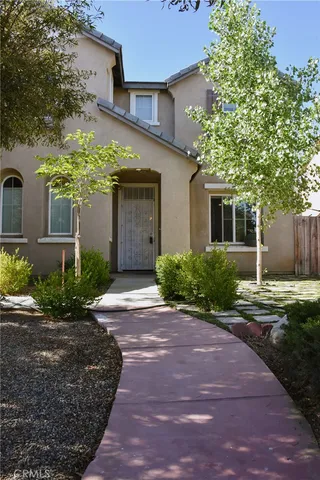 a view of a house with flower plants