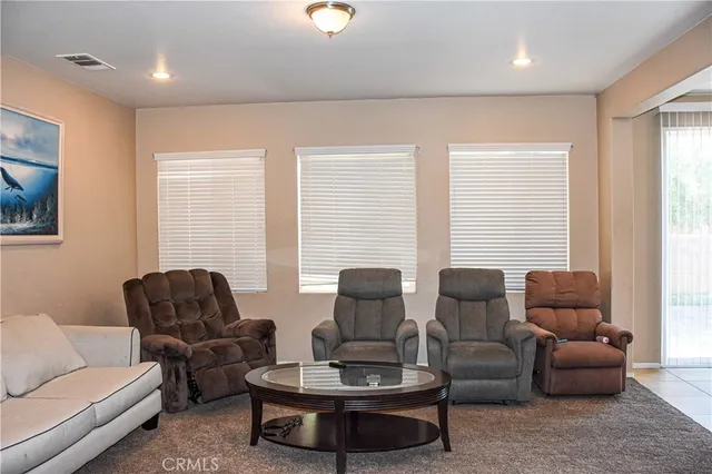 a view of a livingroom with furniture and a window
