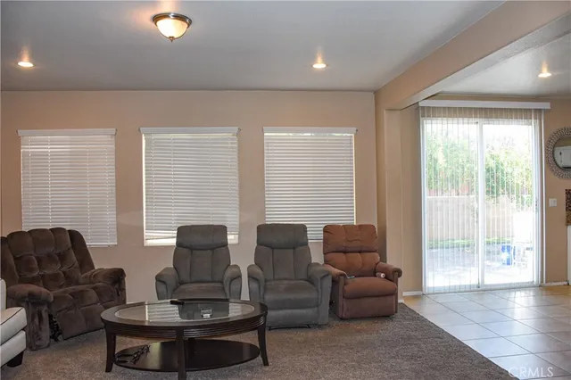 a living room with furniture a window and potted plants