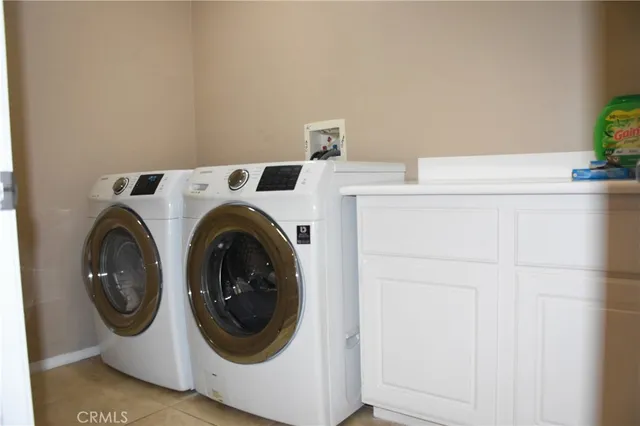 a view of an empty room with closet and a bathroom