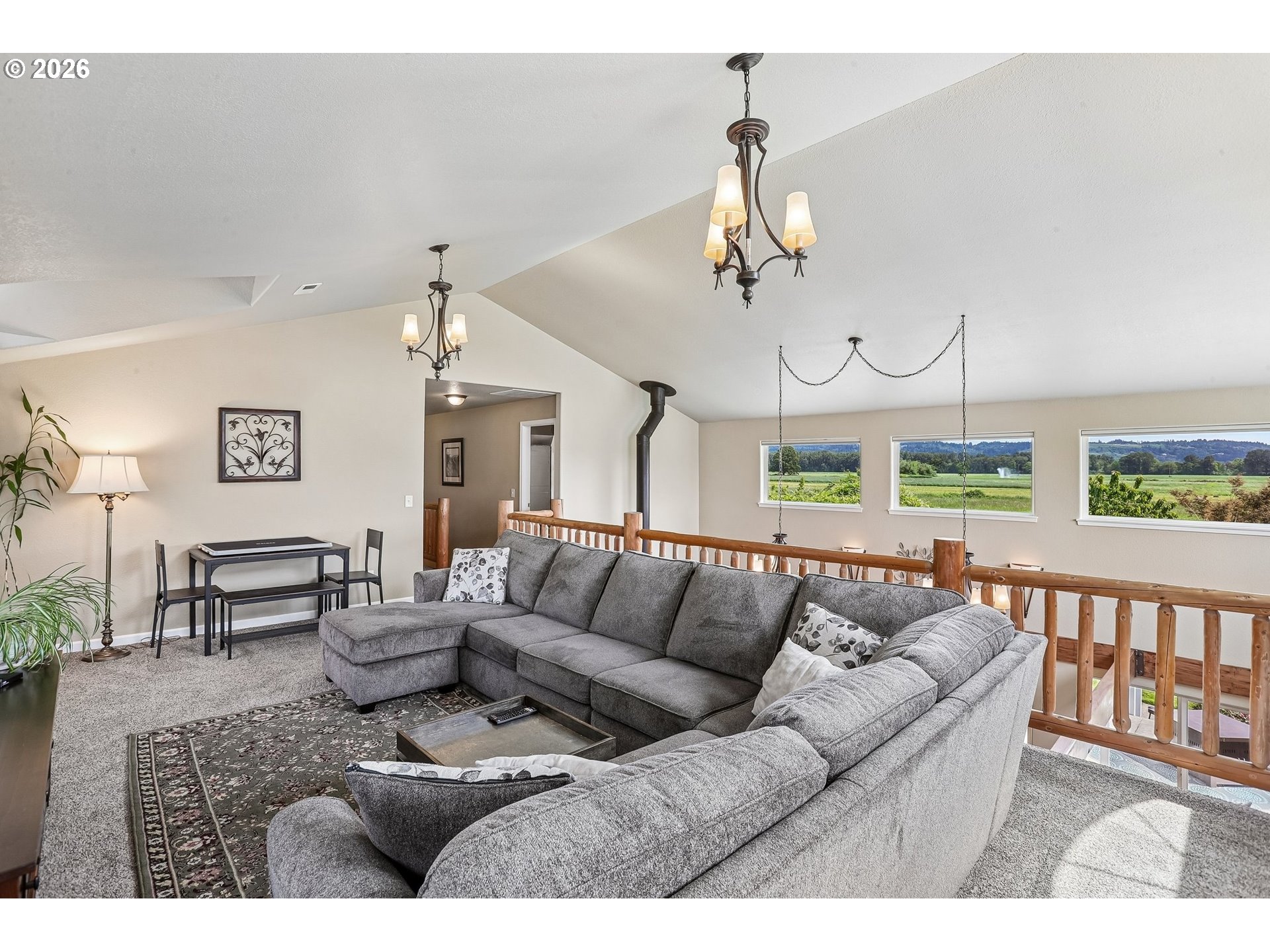 298 Roberson Road Woodland, WA 98674 - Photo 17 of 48 a living room with furniture a dining table and a chandelier