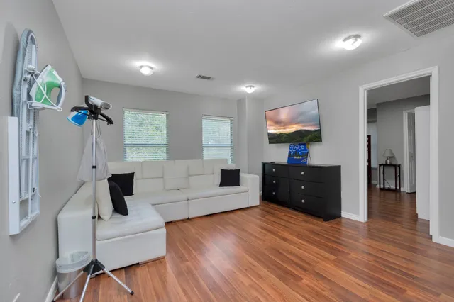 a living room with furniture and a flat screen tv