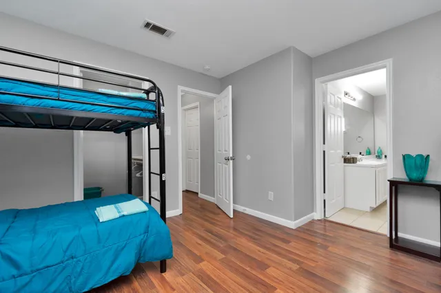 a bedroom with a bed and a potted plant