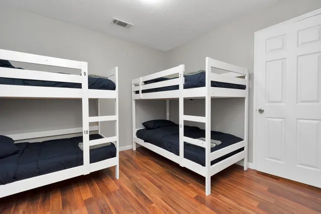 a bedroom with two beds and a window