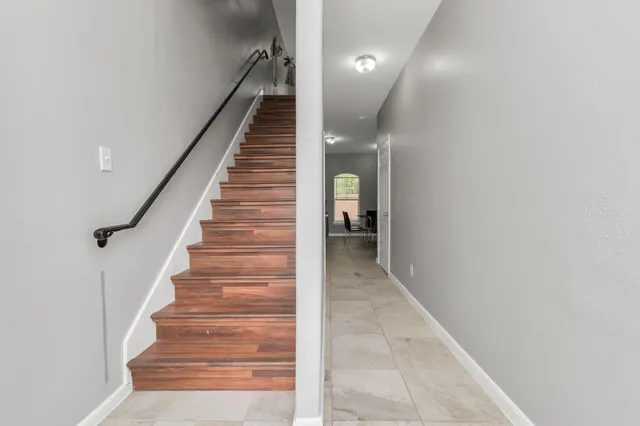 a view of entryway and hall with wooden floor