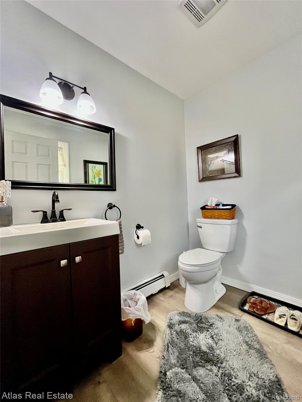 12026 Coolidge Road Goodrich, MI 48438 - Photo 46 of 56 Dark wood-finish vanity with white rectangular sink, matte black faucet, and frameless mirror