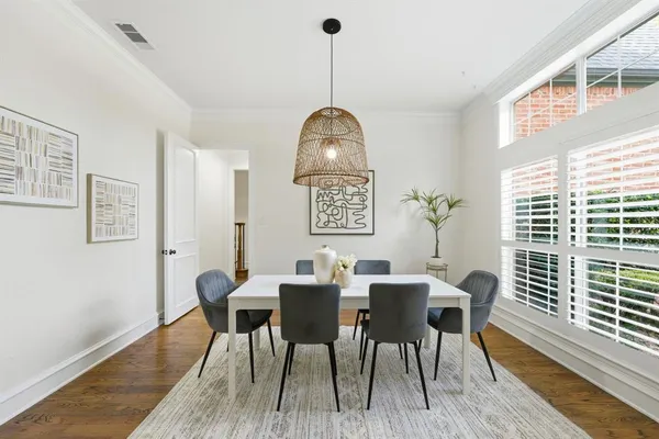 a view of a dining room with furniture window and wooden floor