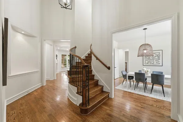 a view of entryway and hall with wooden floor