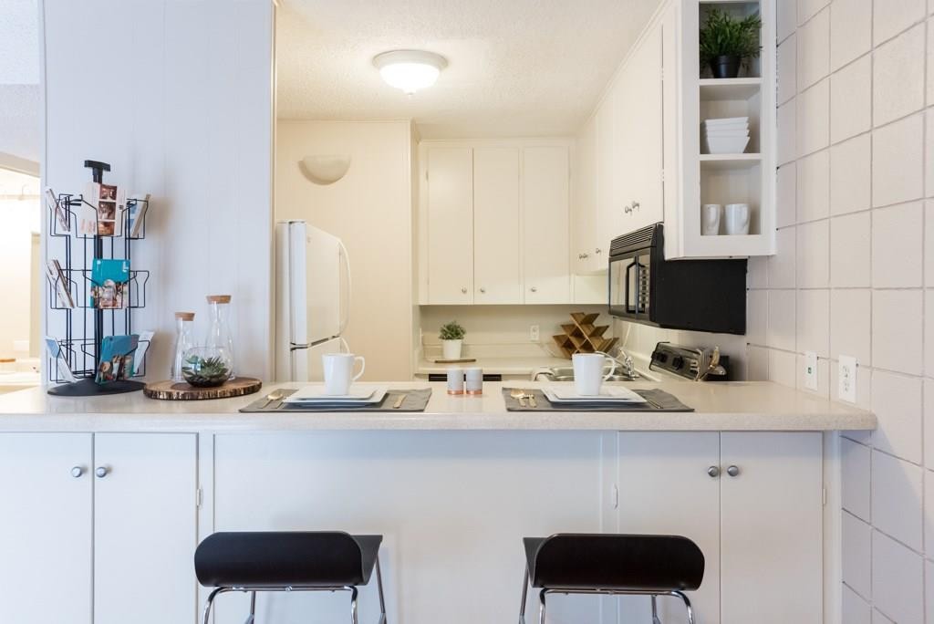 3212 Red River Street, Unit 207 Austin, TX 78705 - Photo 4 of 9 a kitchen with a sink and cabinets