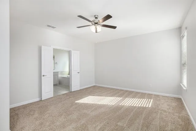 a view of a livingroom with a ceiling fan & wooden floor