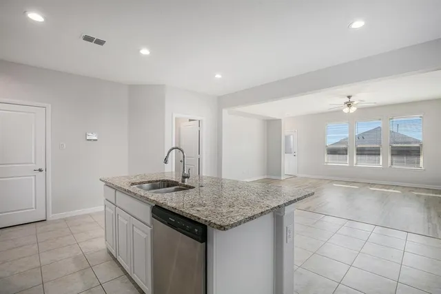 a kitchen with stainless steel appliances granite countertop a sink and a granite counter tops