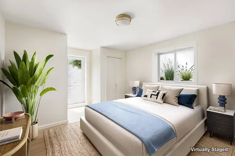 a bedroom with bed and a potted plant