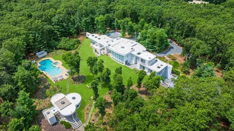 an aerial view of a house with a yard basket ball court and outdoor seating