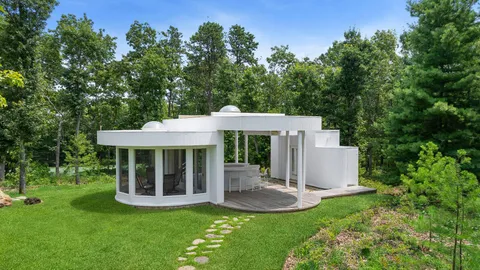 a view of a house with backyard porch and sitting area