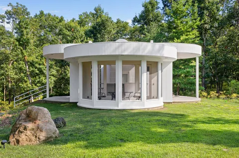 a view of a house with backyard porch and sitting area