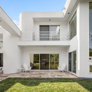 a house with swimming pool in front of it