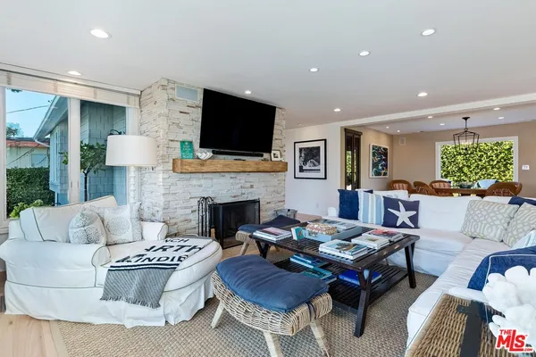 a living room with fireplace furniture and a flat screen tv