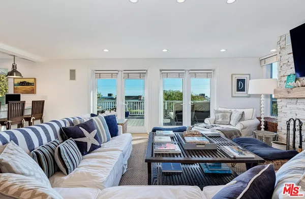 a living room with furniture a fireplace and a table