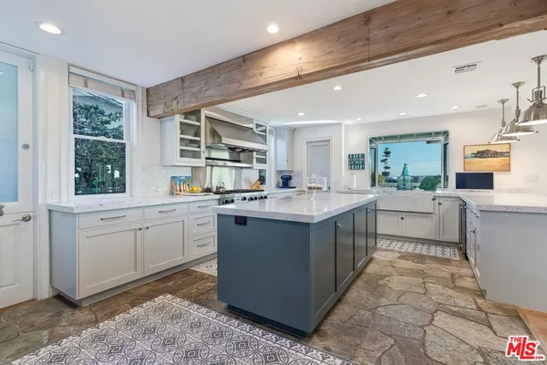 a large kitchen with a lot of counter space and a sink