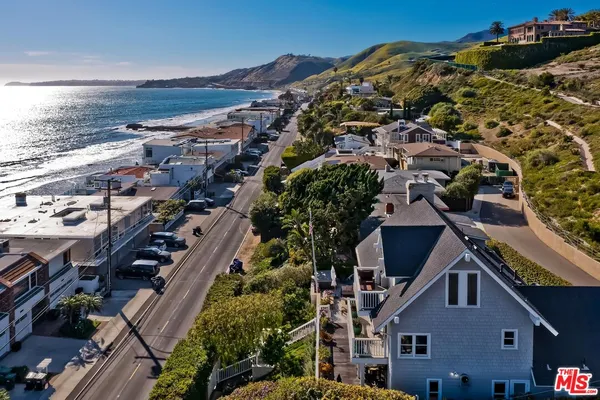 an aerial view of multiple houses with a yard