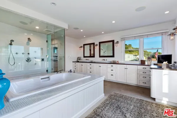 a bath tub sitting in a bathroom next to a window