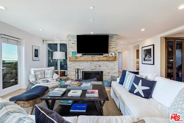 a living room with furniture fireplace and flat screen tv
