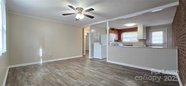 a kitchen with refrigerator cabinets and wooden floor