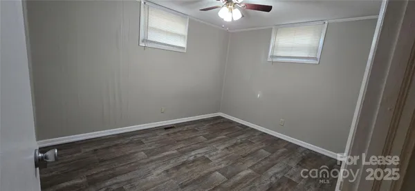 a view of an empty room and wooden floor