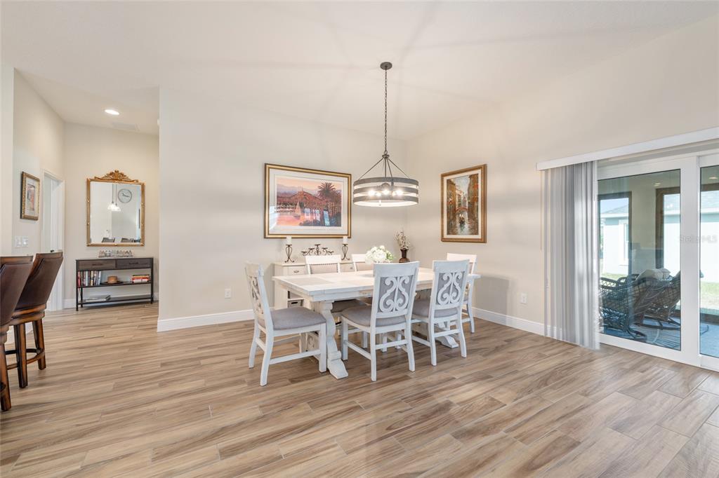 595 Randall Road The Villages, FL 32163 - Photo 11 of 42 a view of a dining room with furniture window and wooden floor