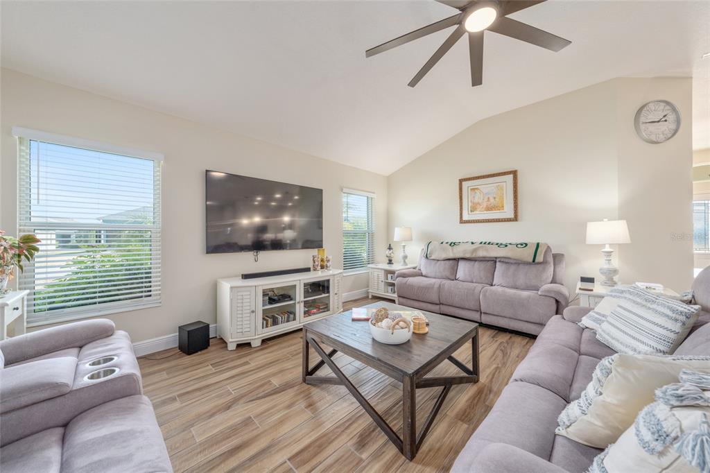 595 Randall Road The Villages, FL 32163 - Photo 13 of 42 a living room with furniture a flat screen tv and a window