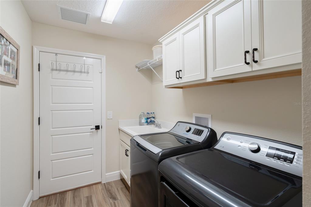 595 Randall Road The Villages, FL 32163 - Photo 15 of 42 a utility room with dryer and washer