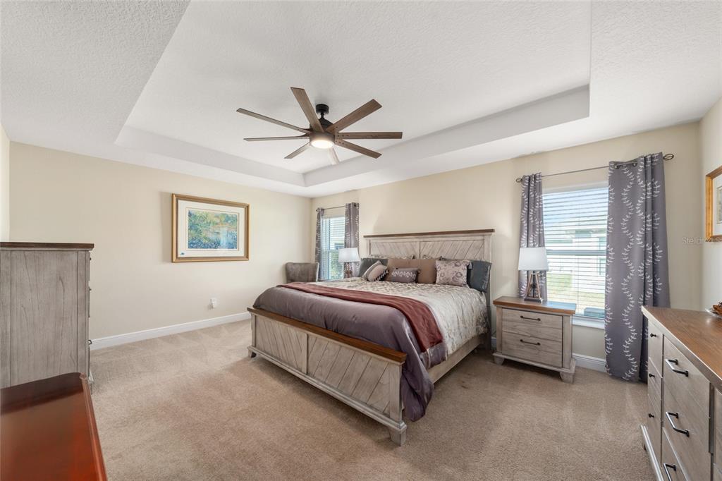 595 Randall Road The Villages, FL 32163 - Photo 17 of 42 a spacious bedroom with a bed and a window
