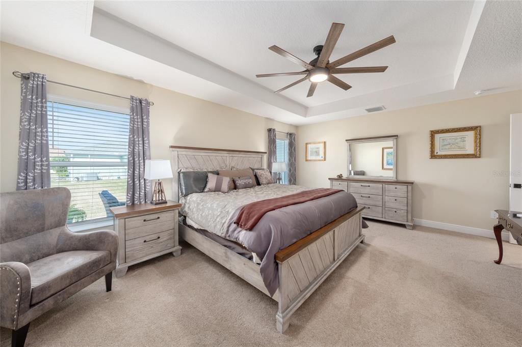 595 Randall Road The Villages, FL 32163 - Photo 19 of 42 a bedroom with a bed couch and window