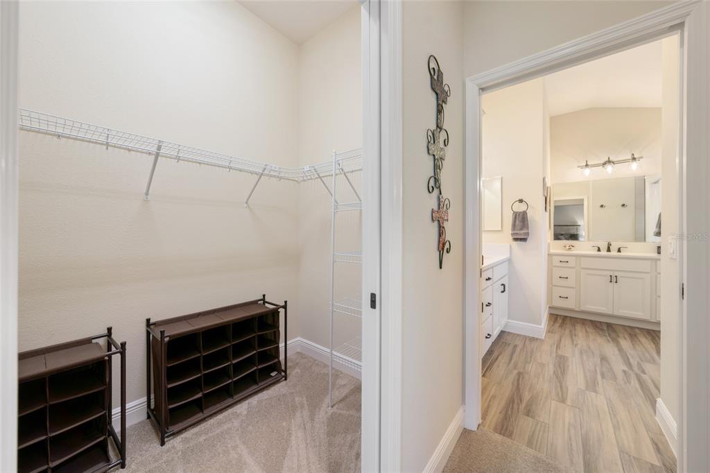 595 Randall Road The Villages, FL 32163 - Photo 20 of 42 a view of a walk in closet and wooden floor