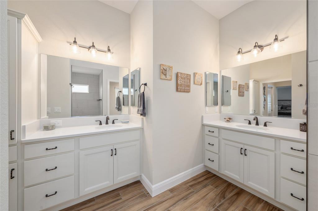 595 Randall Road The Villages, FL 32163 - Photo 22 of 42 a spacious bathroom with a double vanity sink and mirror