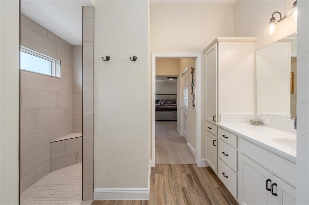 595 Randall Road The Villages, FL 32163 - Photo 24 of 42 a spacious bathroom with a double vanity sink a mirror and a shower