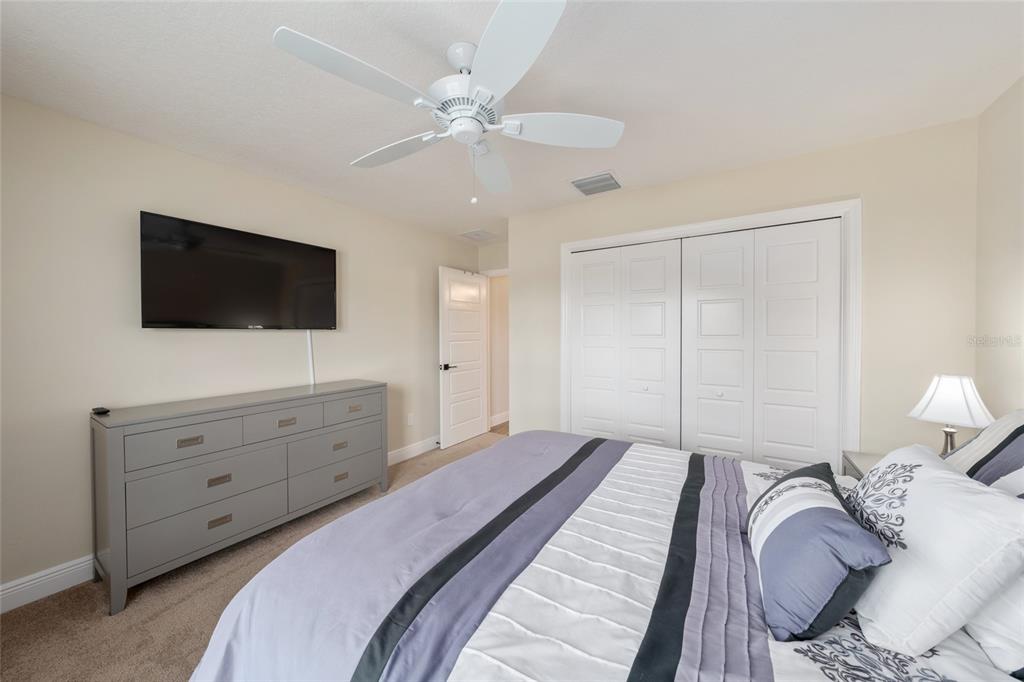 595 Randall Road The Villages, FL 32163 - Photo 29 of 42 a bedroom with a bed and a flat screen tv