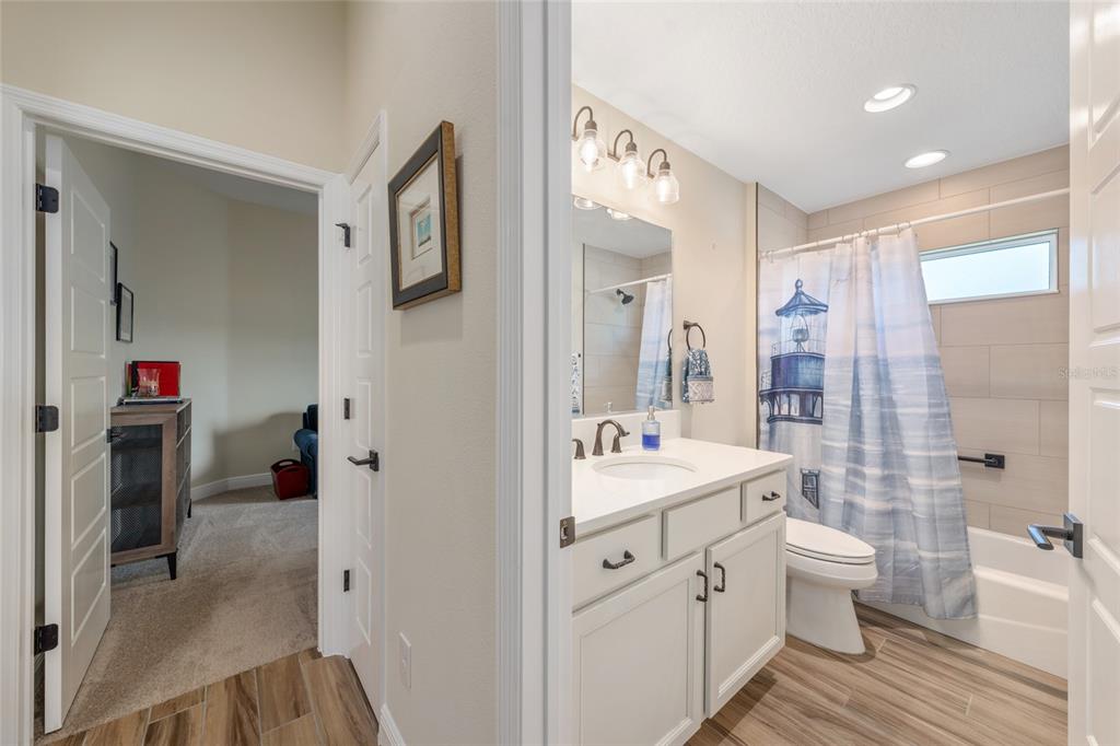 595 Randall Road The Villages, FL 32163 - Photo 31 of 42 a bathroom with a double vanity sink toilet mirror and shower