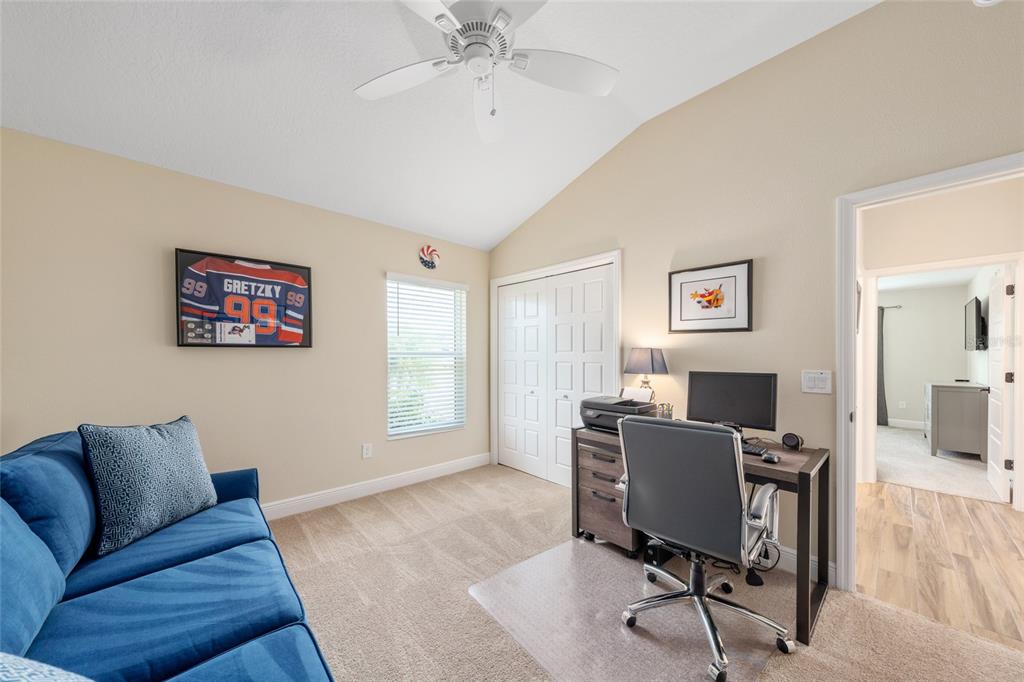 595 Randall Road The Villages, FL 32163 - Photo 33 of 42 a view of a livingroom with workspace and a couch