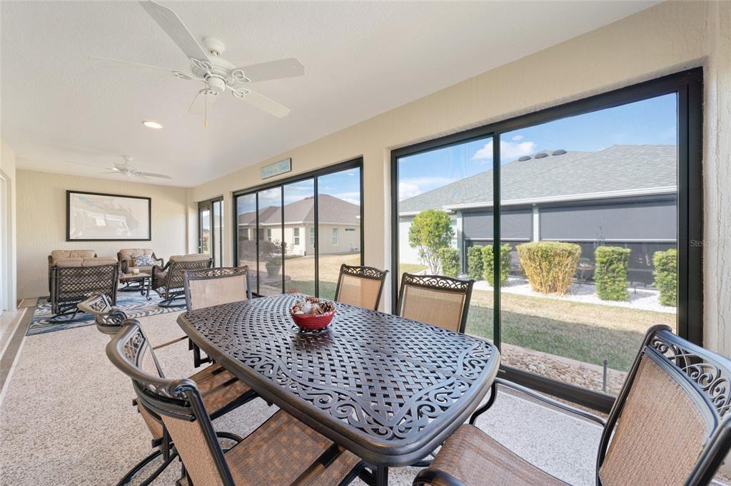 595 Randall Road The Villages, FL 32163 - Photo 36 of 42 a dining room with furniture a chandelier and wooden floor
