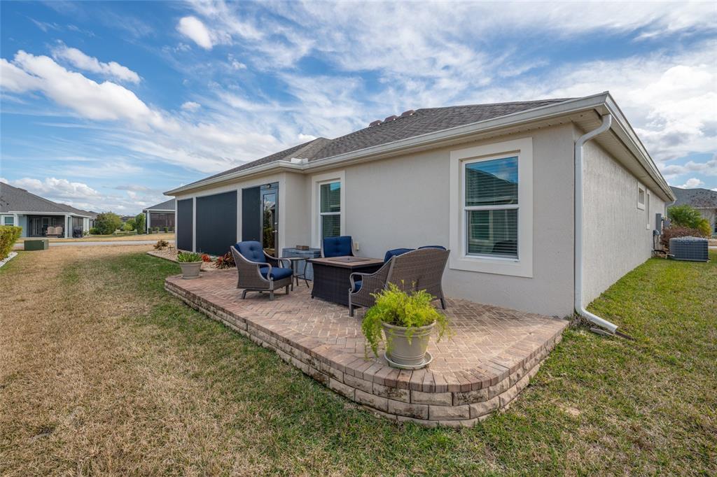 595 Randall Road The Villages, FL 32163 - Photo 37 of 42 a view of a house with backyard porch and sitting area