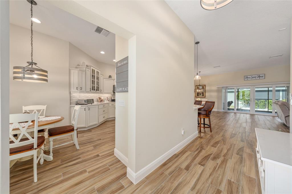 595 Randall Road The Villages, FL 32163 - Photo 4 of 42 a view of kitchen and dining room with wooden floor
