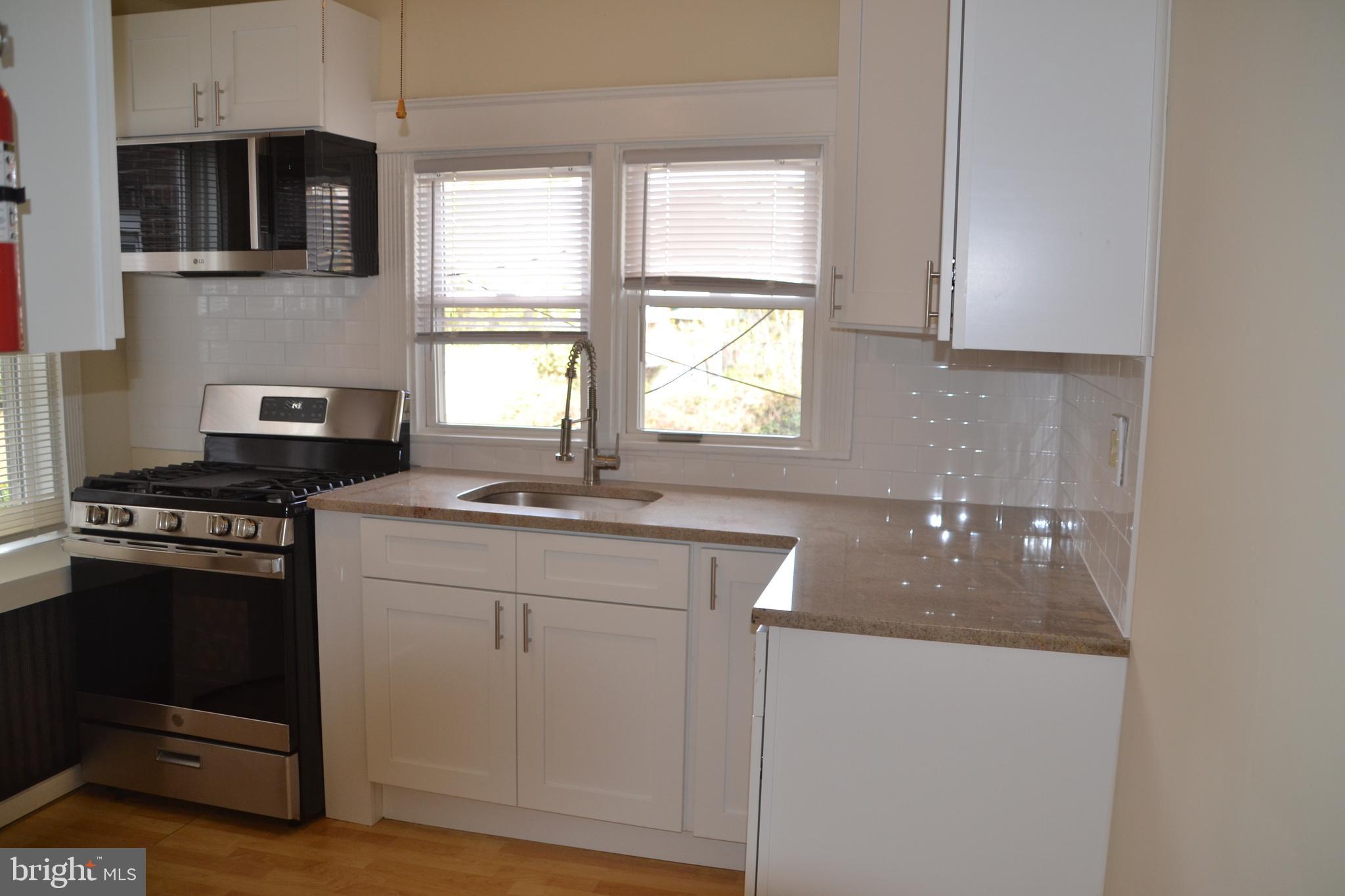 243 Coverly Road Lansdowne, PA 19050 - Photo 9 of 31 a kitchen with a sink stove and window