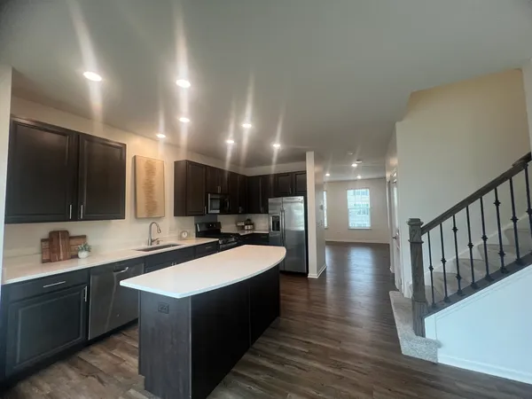 a large white kitchen with a large island in the center